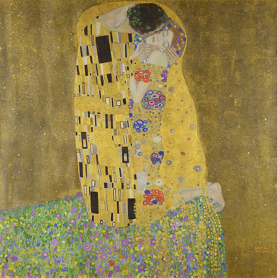 A couple embracing in gold patterned robes in Gustav Klimt’s The Kiss.