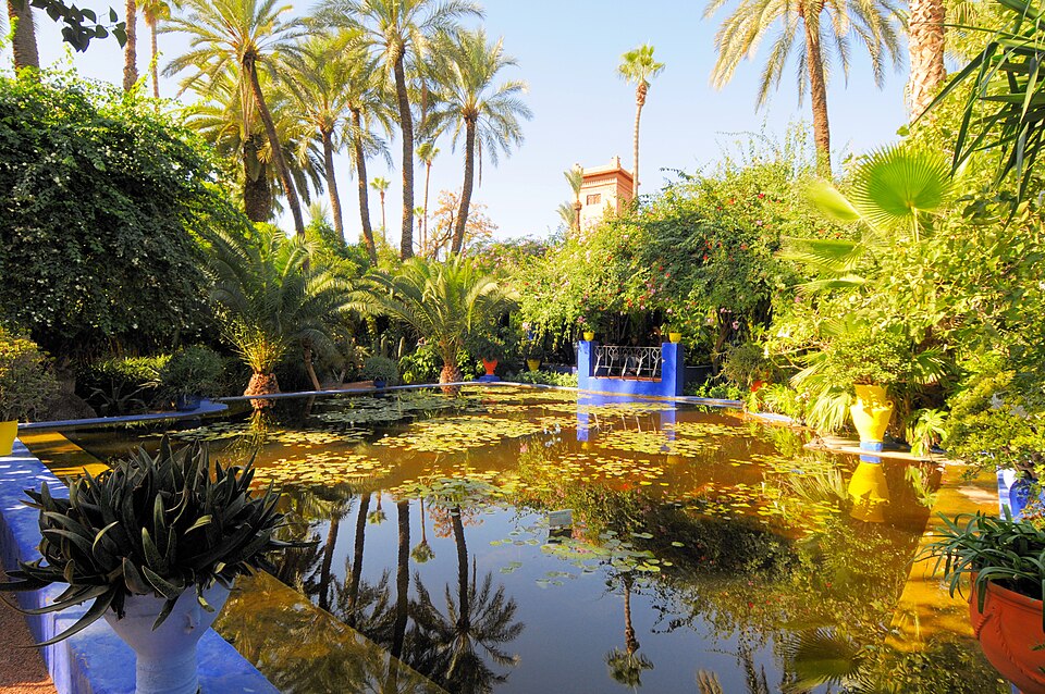 A photograph of a vivid blue building among plants in the Majorelle Garden.