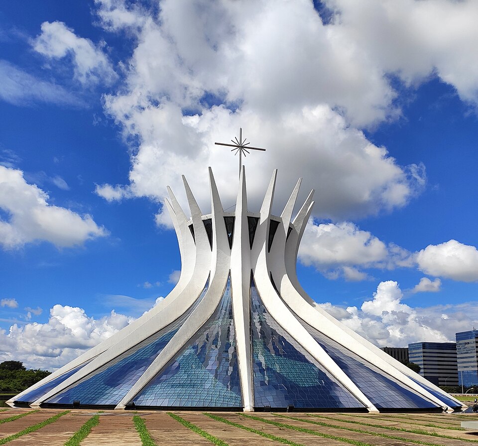 Cathedral of Brasília with upward-curving white structural ribs and a cross against blue sky.