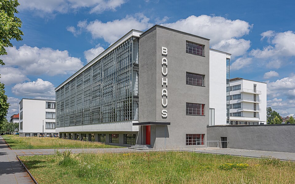 Bauhaus Dessau building with a glass curtain wall and vertical Bauhaus lettering.