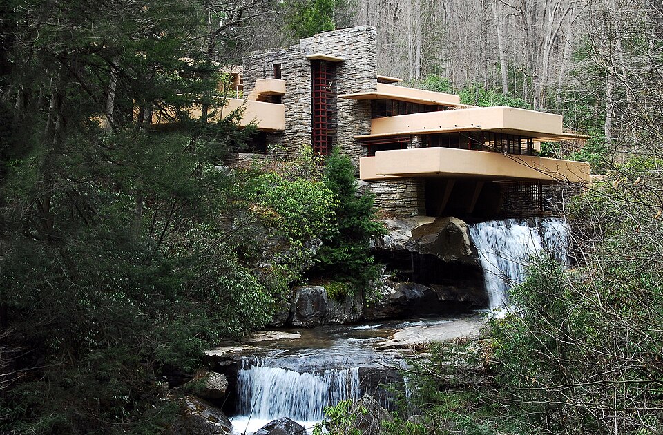 Fallingwater’s cantilevered terraces extending above a rocky stream and waterfall.